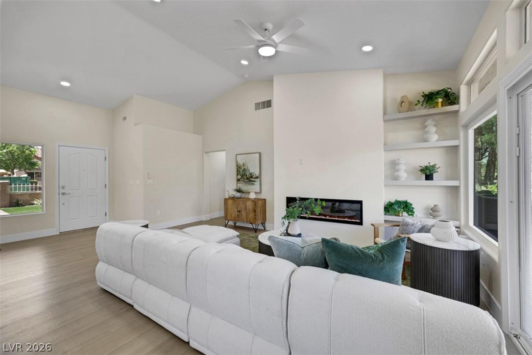 Image 4: An inviting living area with high ceilings and a s