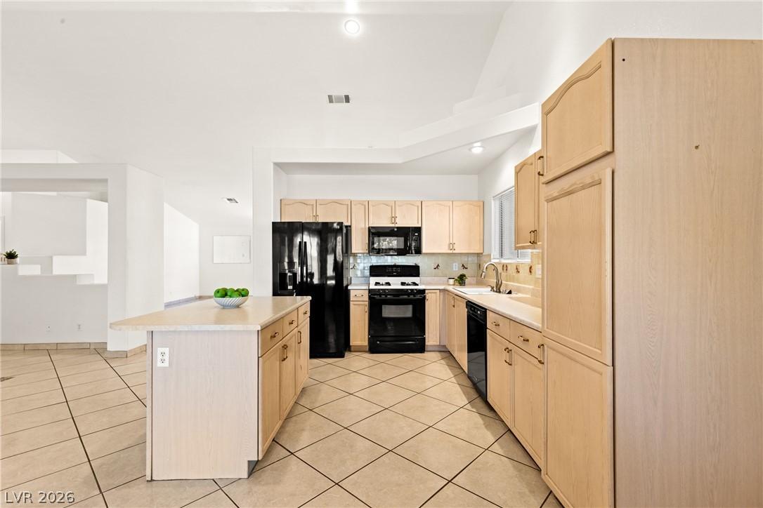 Image 2: Clean kitchen with island seating and abundant sto