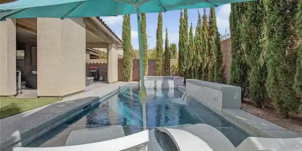 Image 3: Mature perimeter trees frame a geometric swimming