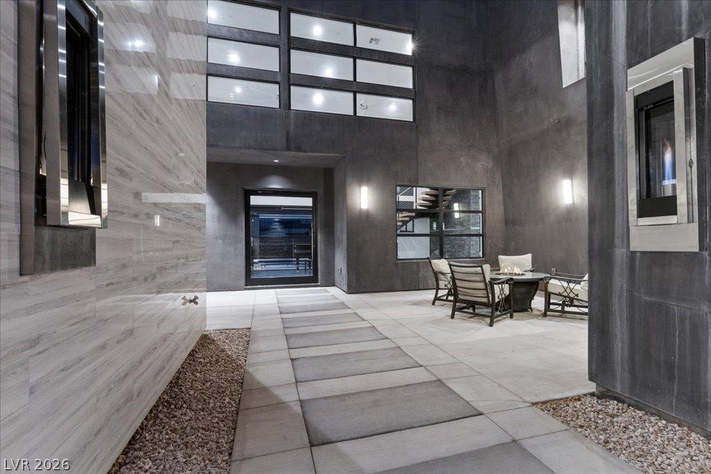 Image 2: An inviting private courtyard features a modern fi