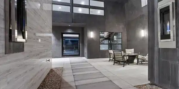 Image 2: An inviting private courtyard features a modern fi