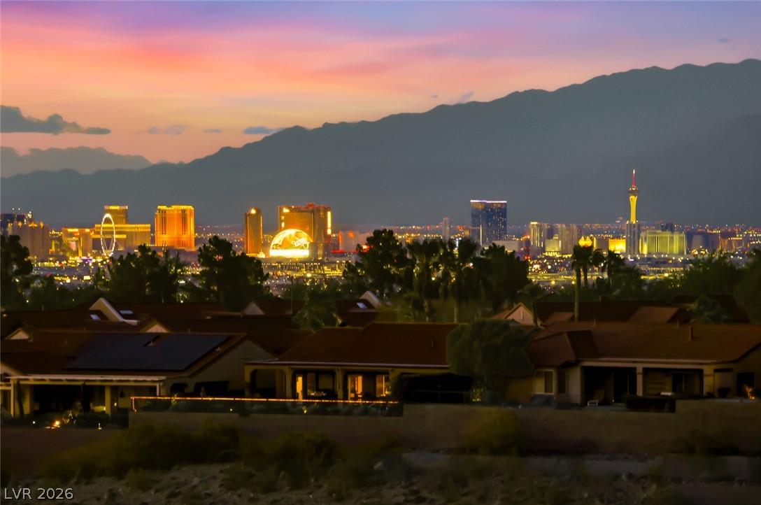Image 3: City lights gleam across the valley, presenting an