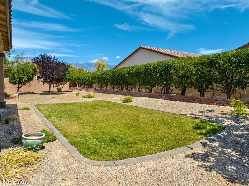 Image 4: This outdoor space features a well-maintained lawn