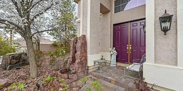 Image 3: A welcoming entry features plum-colored double doo