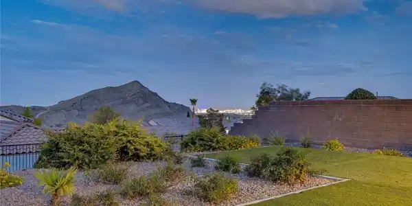 Image 3: A well-maintained landscape reveals distant city l