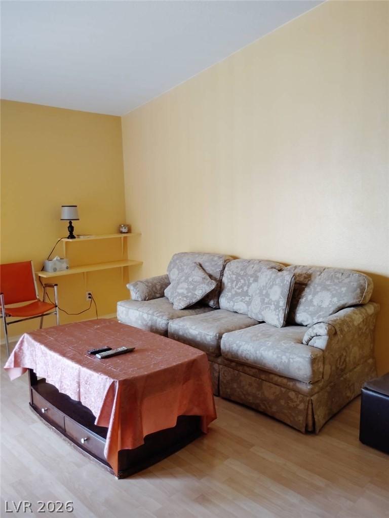 Image 2: A relaxed living area with warm walls and light wo