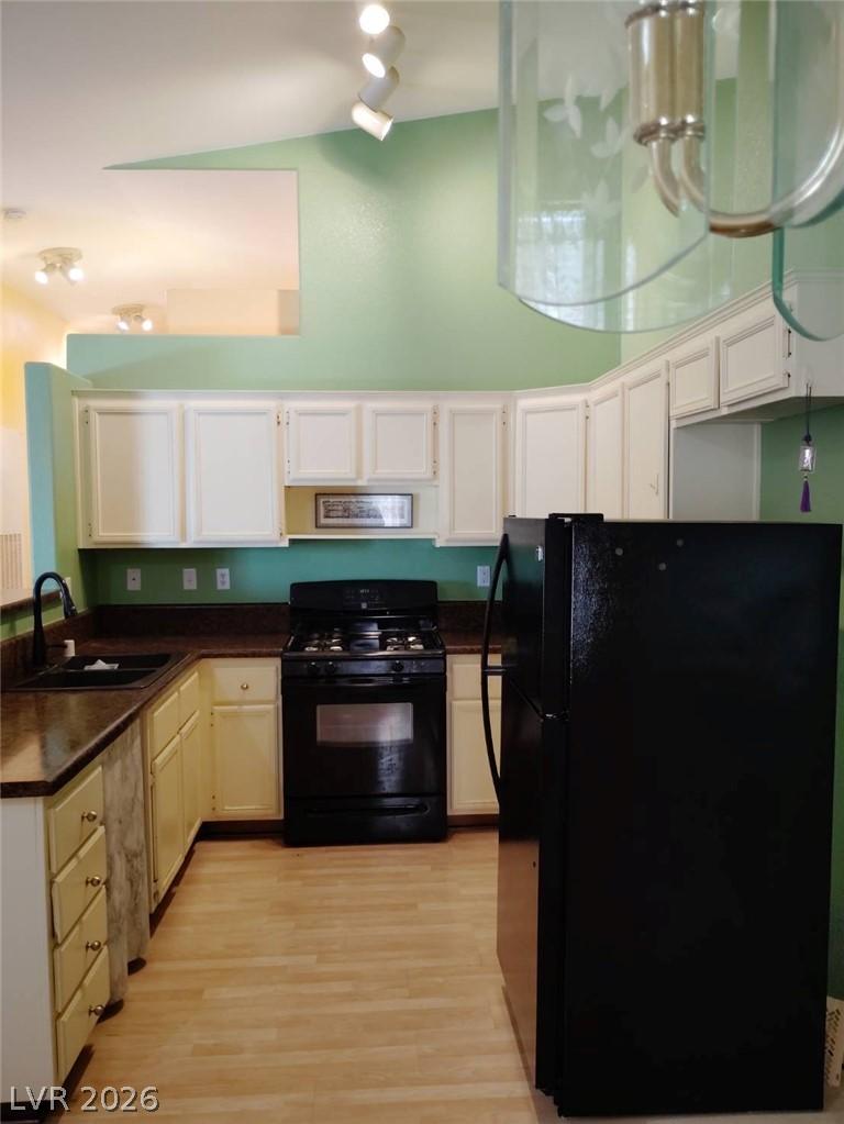 Image 4: A well-appointed kitchen features laminate floorin