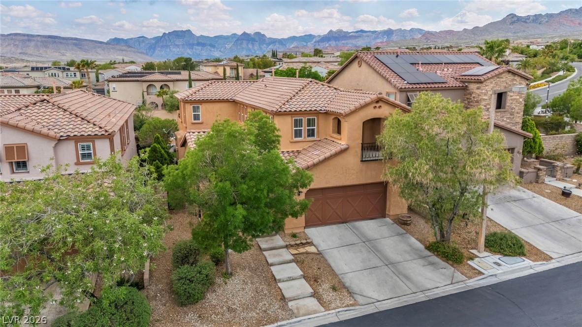 Image 3: This two-story home features solar panels and moun