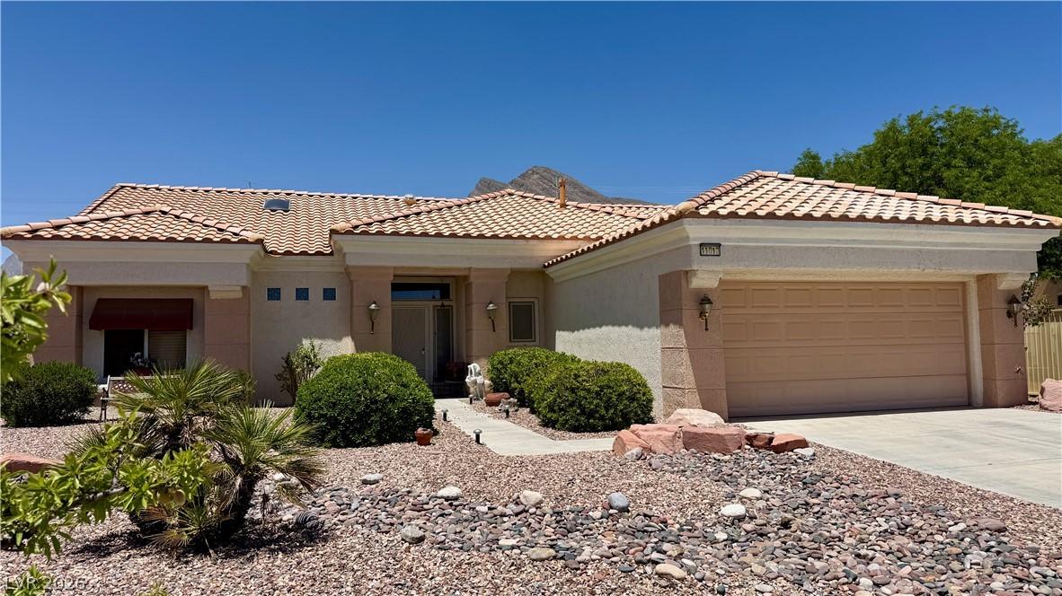 Image 2: A terracotta tile roof tops this desert-landscaped