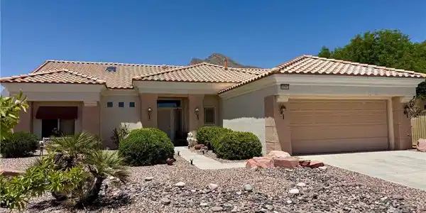 Image 2: A terracotta tile roof tops this desert-landscaped