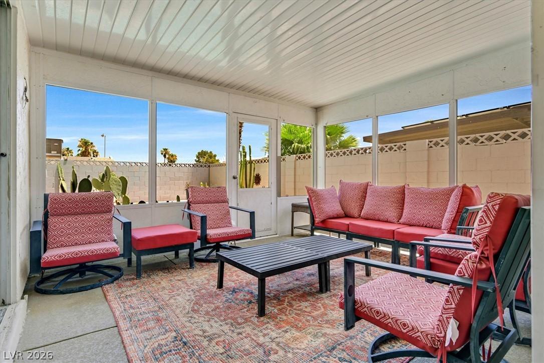 Image 4: A relaxed covered patio offers ample seating and d