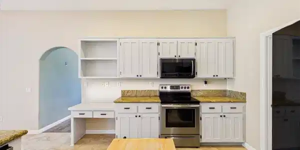 Image 2: A well-appointed kitchen features ample cabinetry,