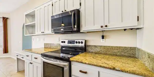 Image 3: Culinary adventures await in this kitchen featurin