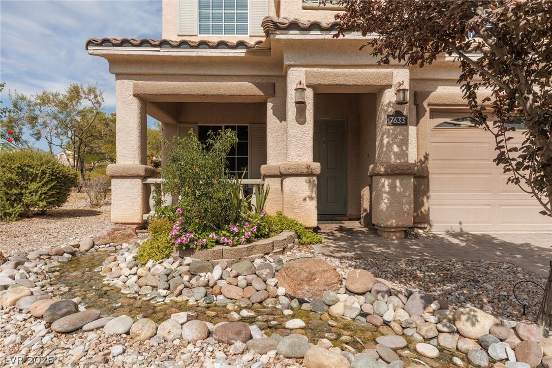 Image 3: A charming stucco exterior features a welcoming co