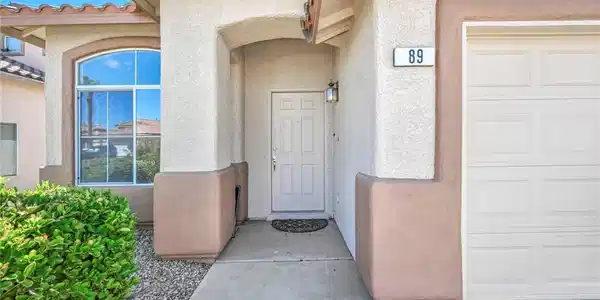 Image 3: An inviting recessed entryway with a solid door si