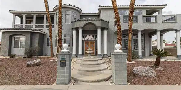 Image 3: Mediterranean / spanish home with stucco siding an