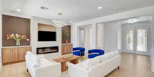 Image 3: Clean lines and a striking fireplace create a welc