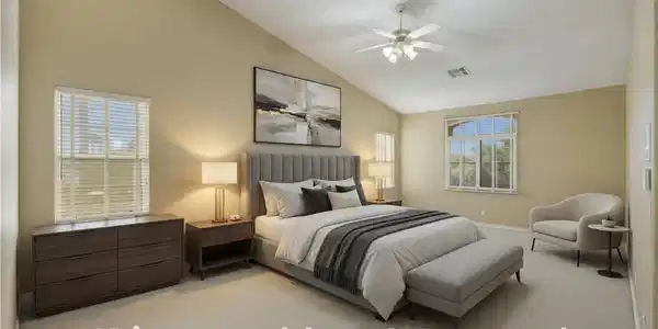 Image 2: An airy primary bedroom awaits, featuring soaring