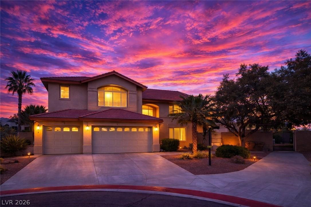Image 3: View of front facade featuring a gate, driveway, s
