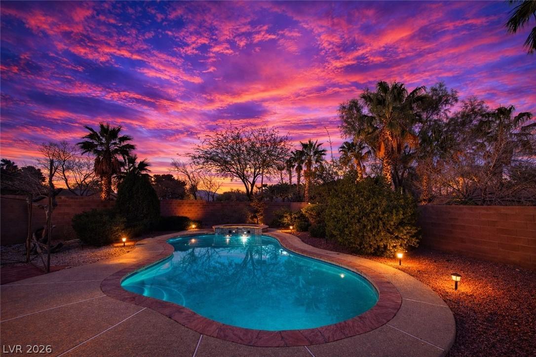 Image 4: Combined pool / hot tub featuring a fenced backyar