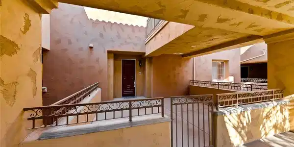 Image 3: A well-lit exterior walkway leads to a private ent