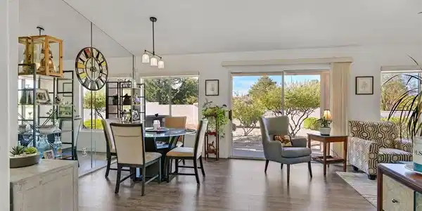 Image 3: Sliding glass doors open to the outdoors from this