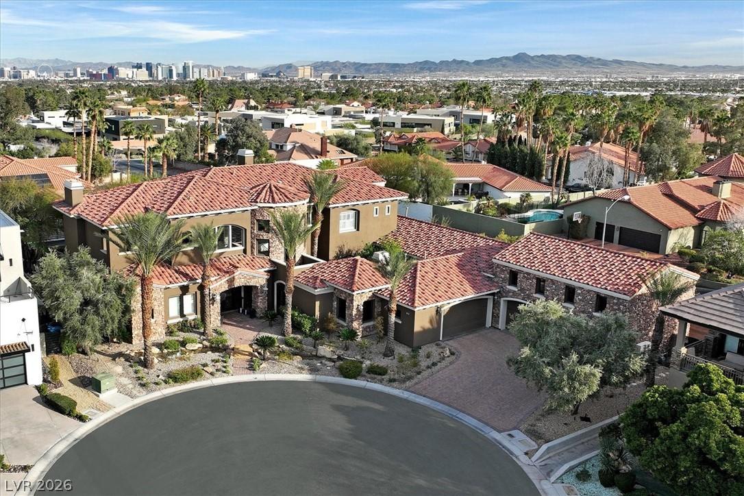 Image 2: Aerial view of residential area featuring a mounta