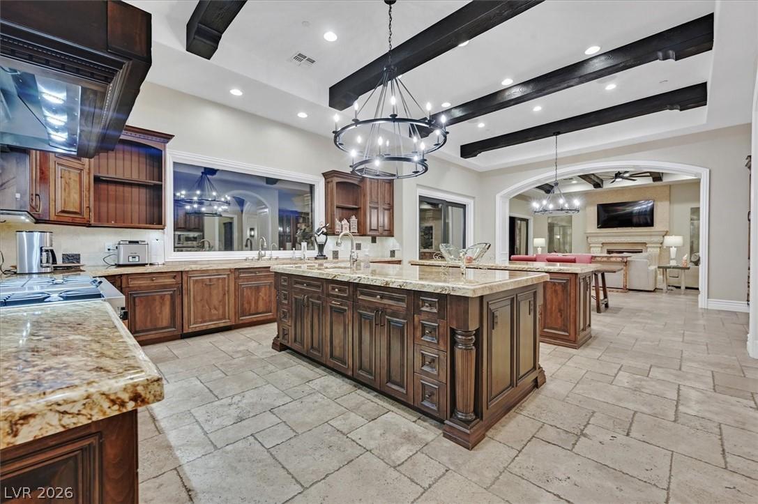 Image 3: Kitchen with a chandelier, open shelves, 2 islands