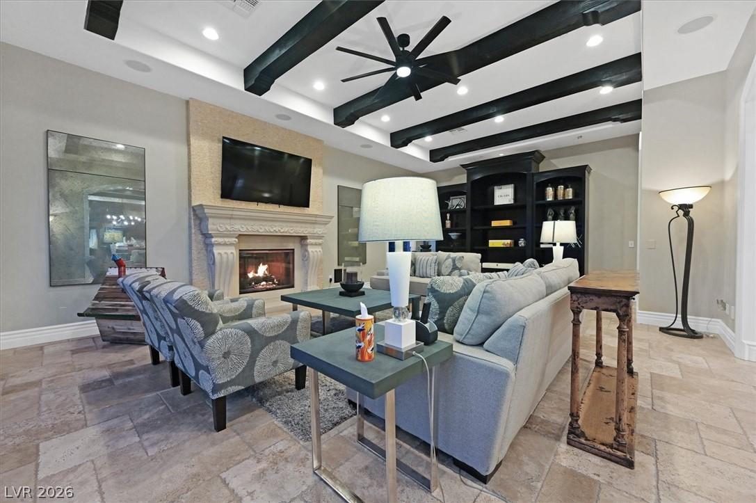 Image 4: Family room featuring stone tile floors, beamed ce