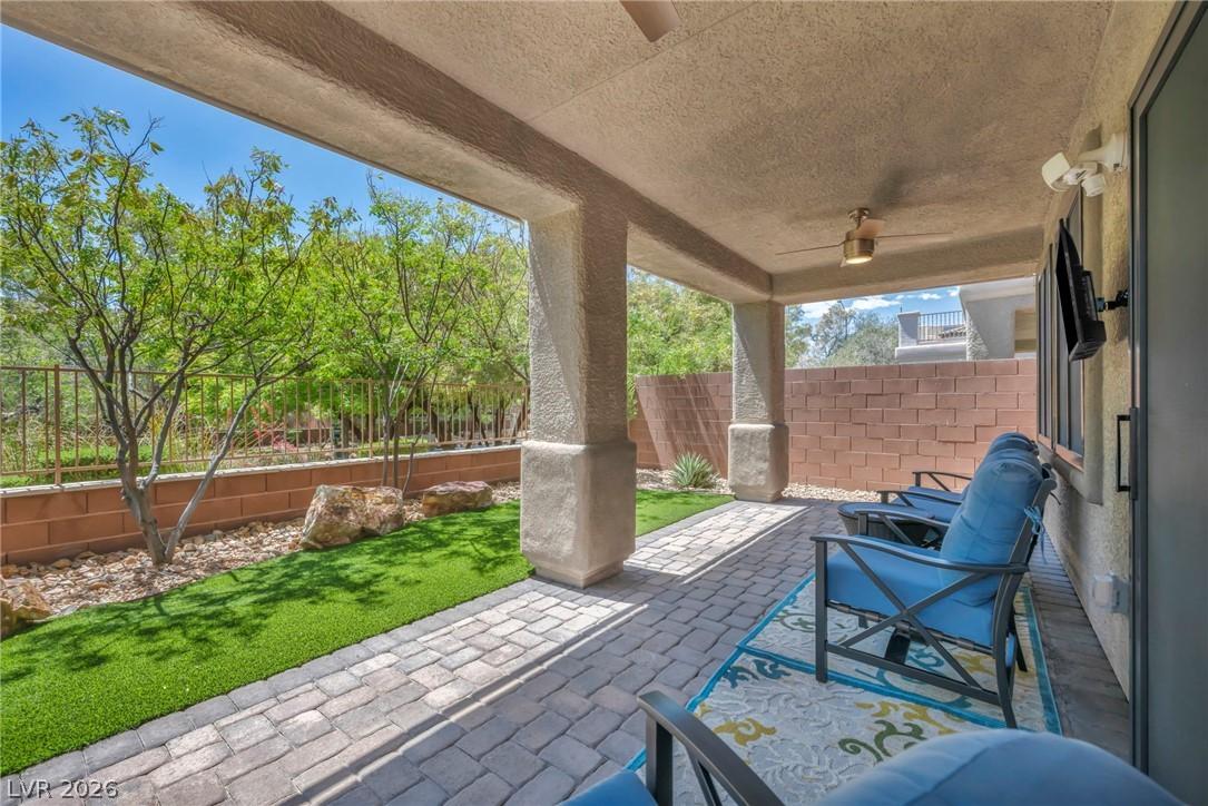 Image 1: Backyard with covered patio and ceiling fans with