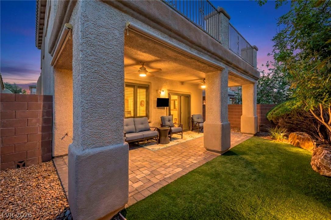 Image 4: Backyard with covered patio and ceiling fans with