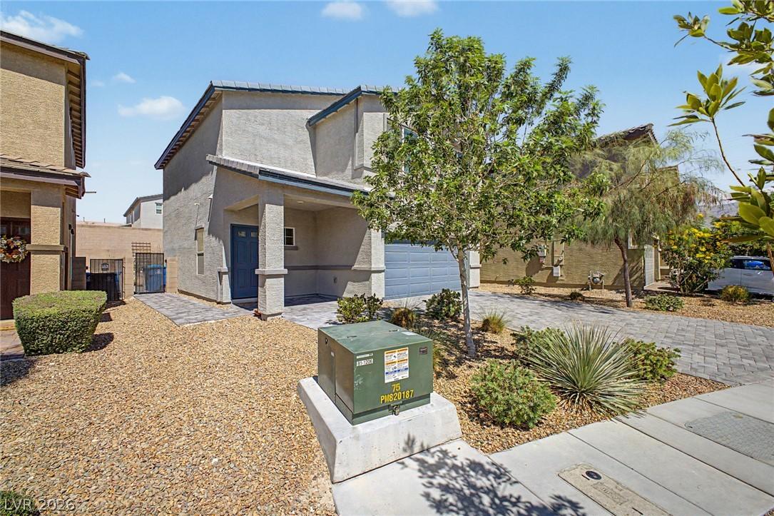 Image 3: A contemporary stucco residence with an integrated