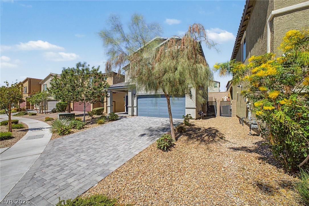 Image 4: A neatly paved driveway leads to a modern residenc