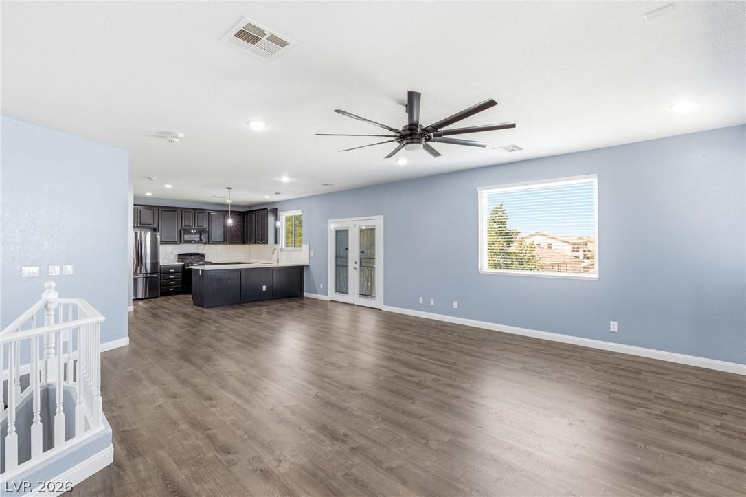Image 3: This bright interior features an open floorplan, c