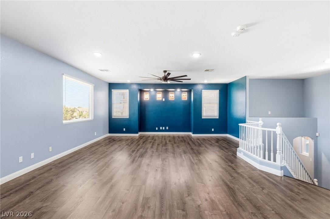 Image 4: This expansive space features rich flooring, large