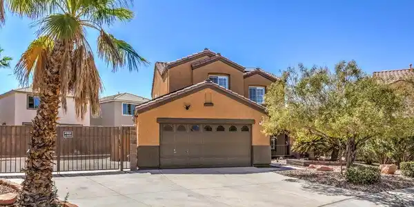 Image 2: A spacious concrete driveway leads to a two-story