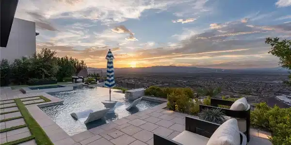 Image 4: An infinity pool and stone terrace frame sweeping