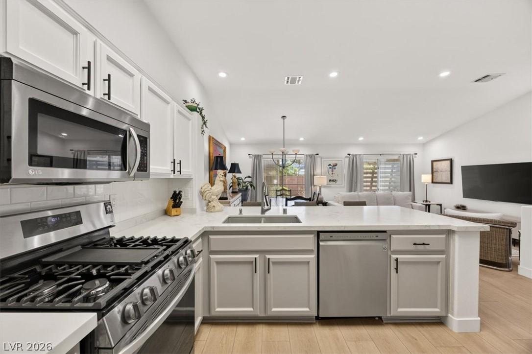 Image 1: Culinary dreams come alive in this kitchen, featur