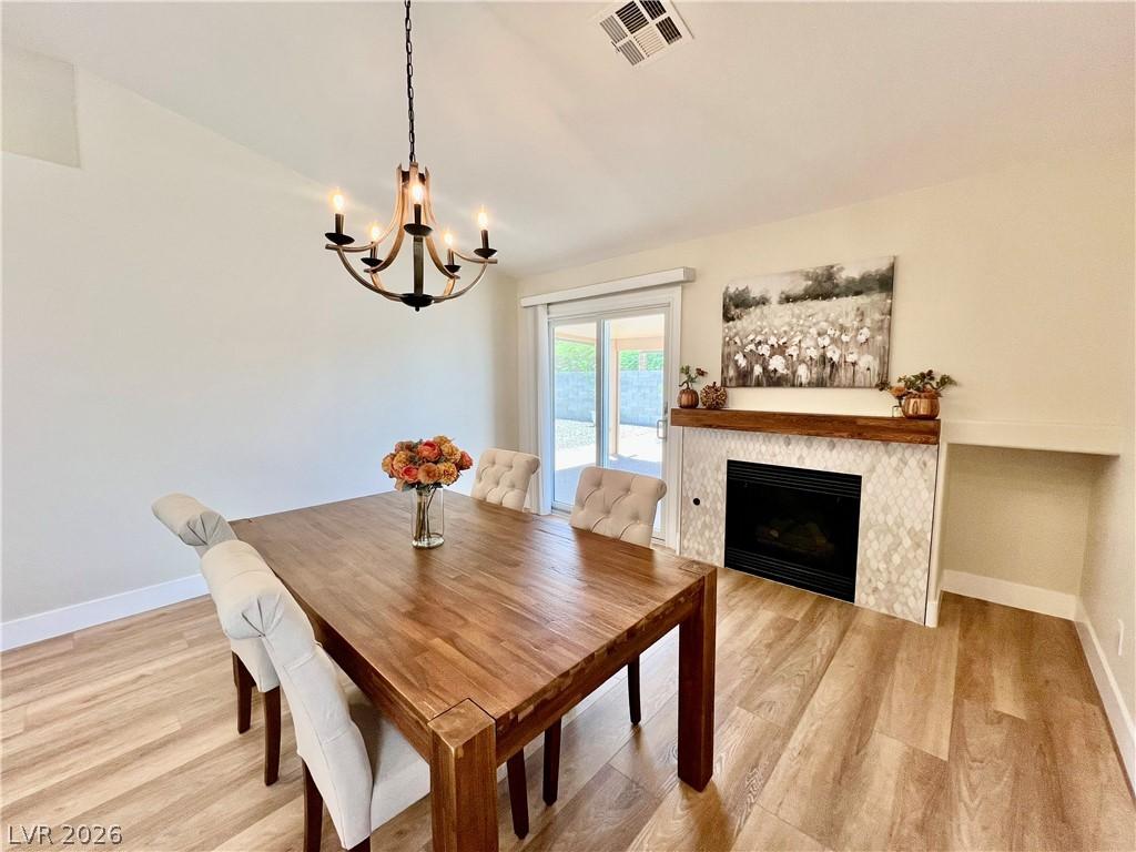 Image 2: A well-lit dining area features a warm wooden tabl