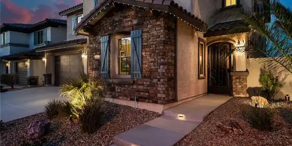 Image 2: Textured stone veneer, traditional tile roofing, a
