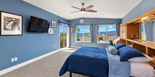 Image 3: A spacious bedroom with carpet flooring, sliding g