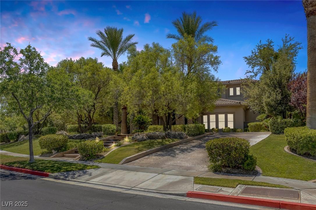 Image 3: View of front facade with decorative driveway, a l