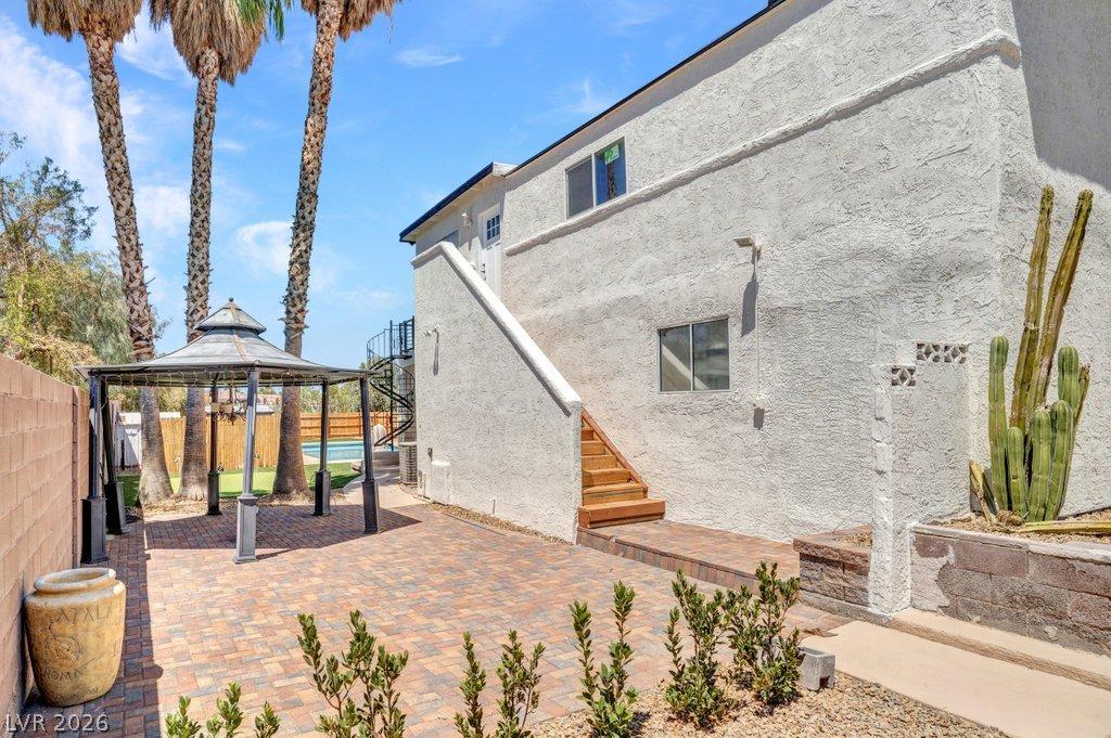 Image 4: A private backyard oasis features an inviting gaze