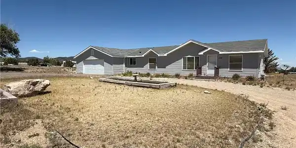 Image 2: A classic ranch home nestled amidst a spacious lot