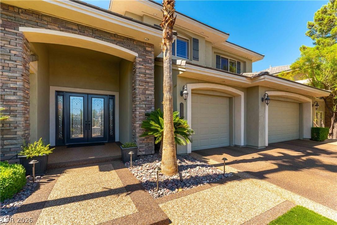 Image 3: Stone accents frame the grand entrance, offering a