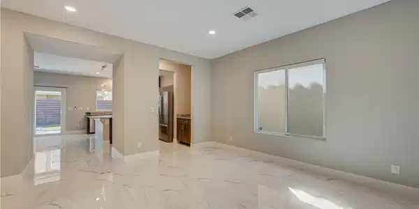 Image 4: Gleaming polished tile floors flow throughout this