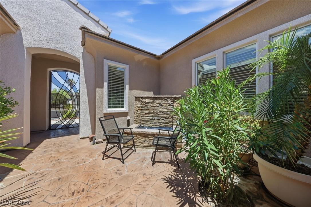 Image 3: An inviting courtyard entrance features a serene s