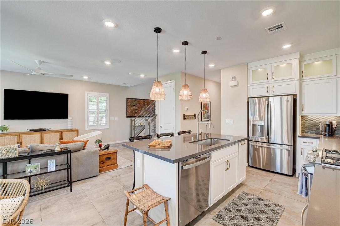 Image 4: The kitchen island, illuminated by pendant lights,