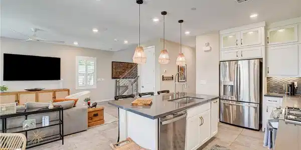 Image 4: The kitchen island, illuminated by pendant lights,