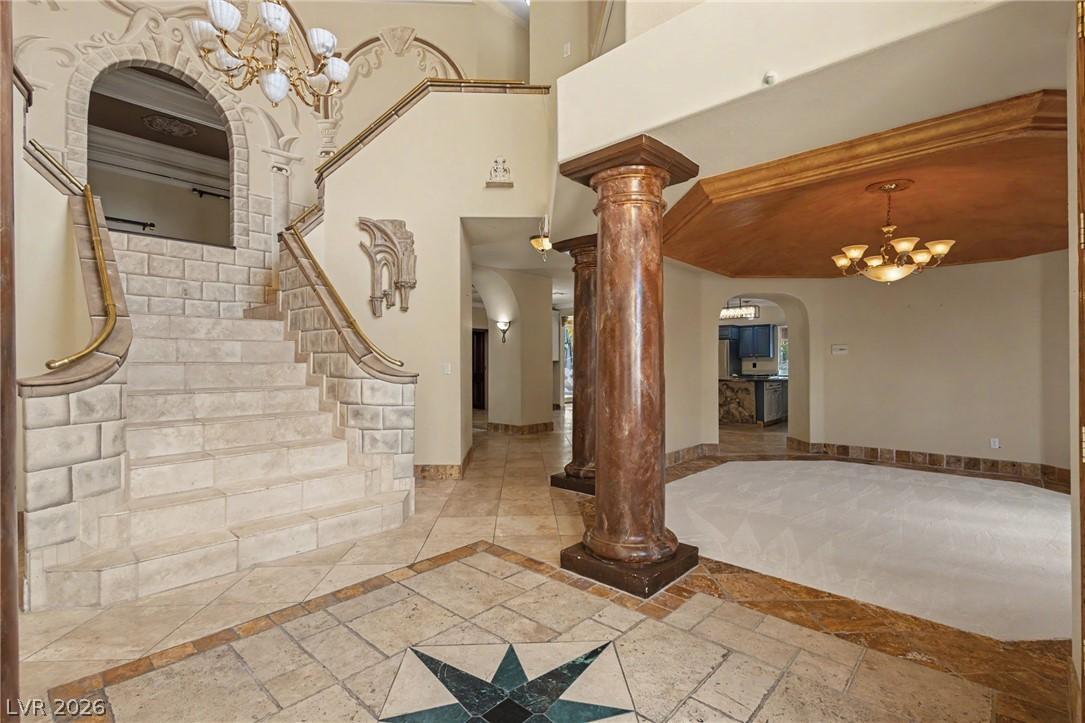 Image 4: A grand entrance welcomes with an ornate staircase